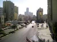 Masjid-e-Jinn (Mosque of the Jinn) and minaret located in front of the tall building between the highway and side street